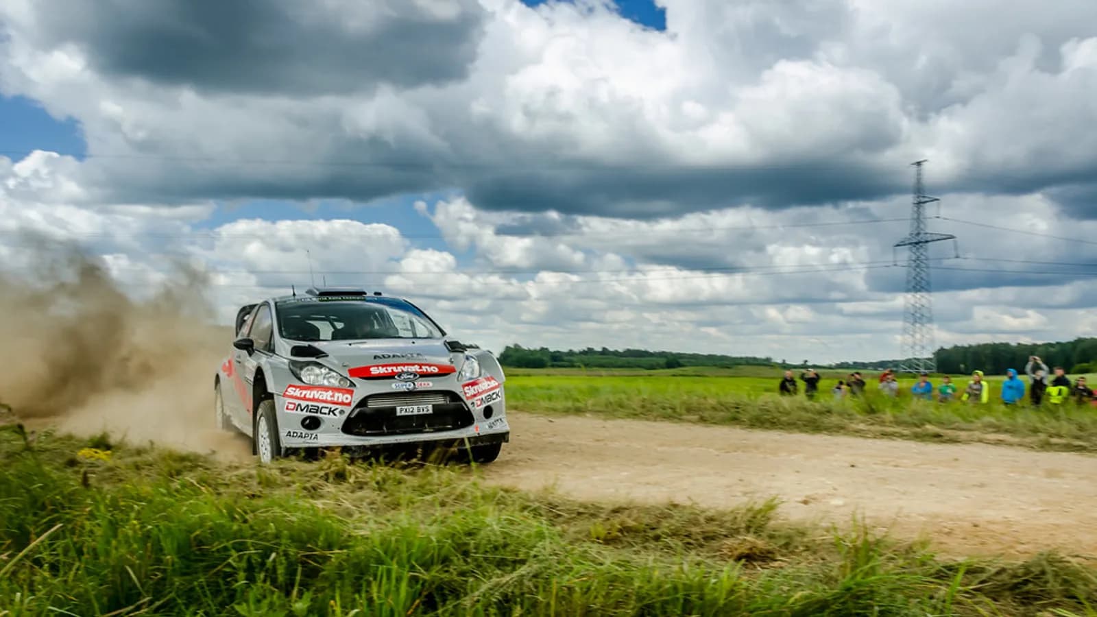 A rally car sideways on a gravel stage